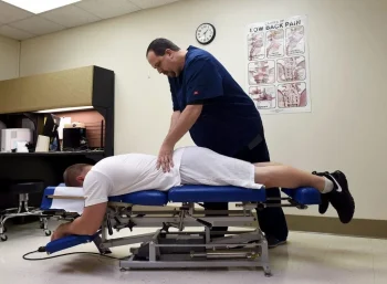 man undergoing treatment for sciatica injury after auto accident