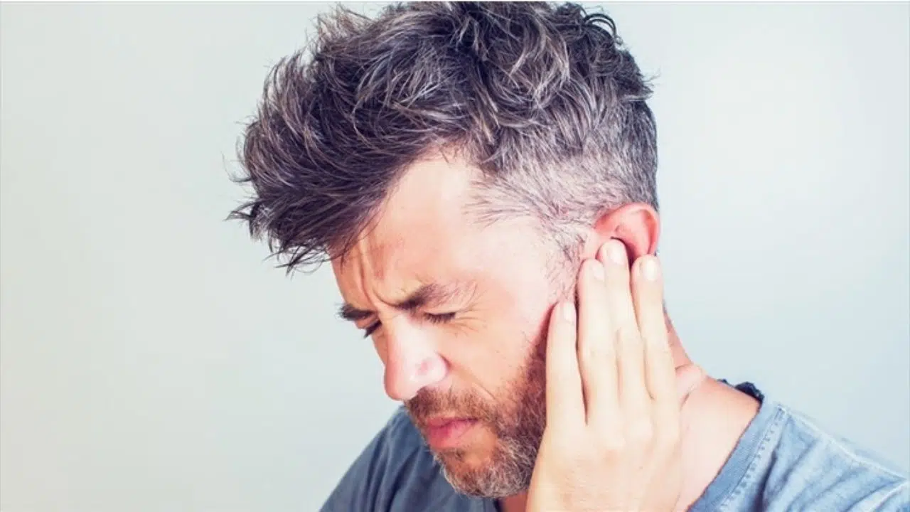 man suffering from tinnitus due to car accident