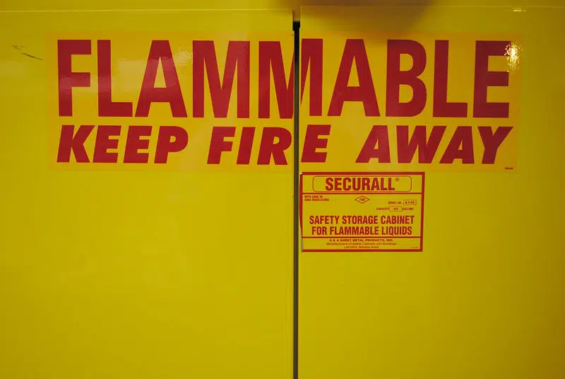 Cabinet for flammable materials aboard a river barge