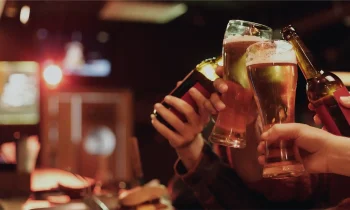 People raising glasses of beer in a Missouri bar or dram shop