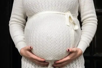 Pregnant person holding their belly