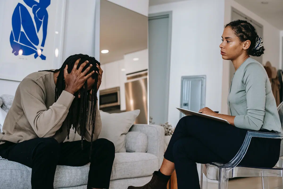 Man with PTSD after a car accident talking to his psychologist 