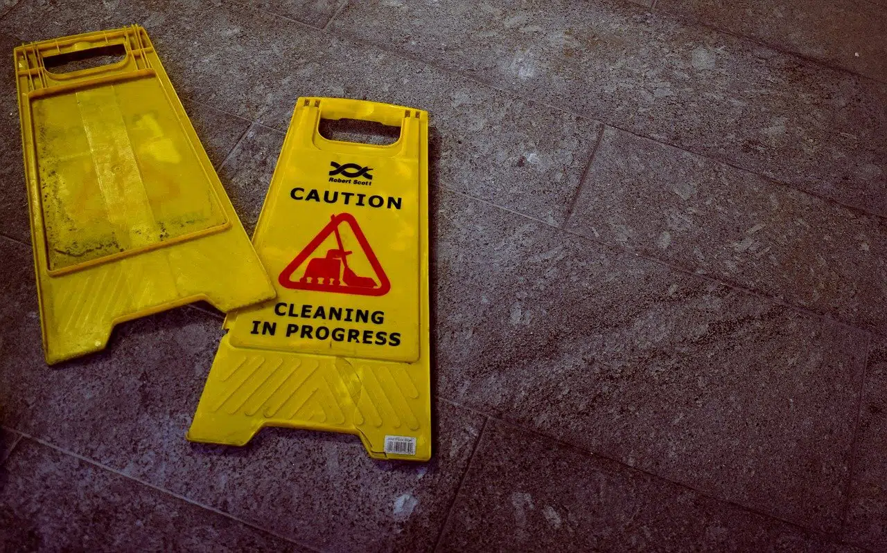 Broken caution sign indicating slip and fall