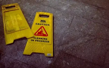 Broken caution sign indicating slip and fall