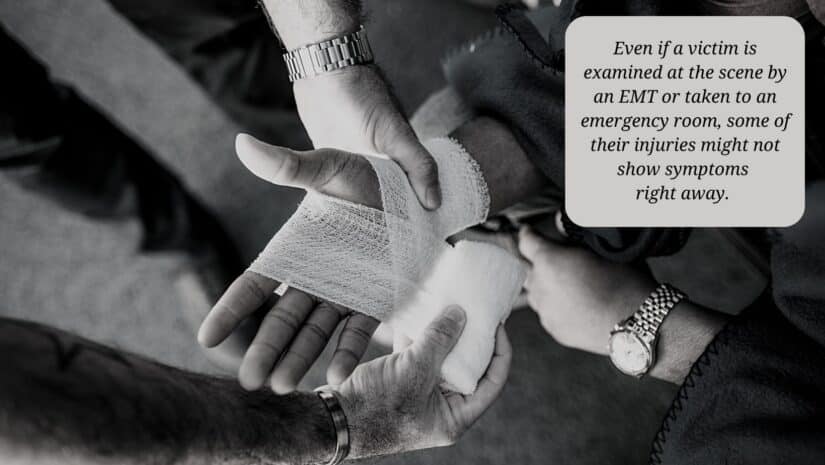 car accident victim's hand being treated by EMT after accident