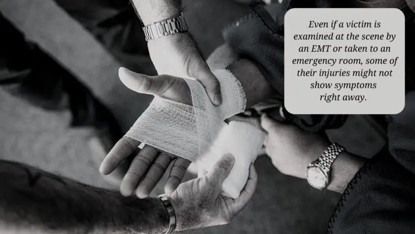 car accident victim's hand being treated by EMT after accident
