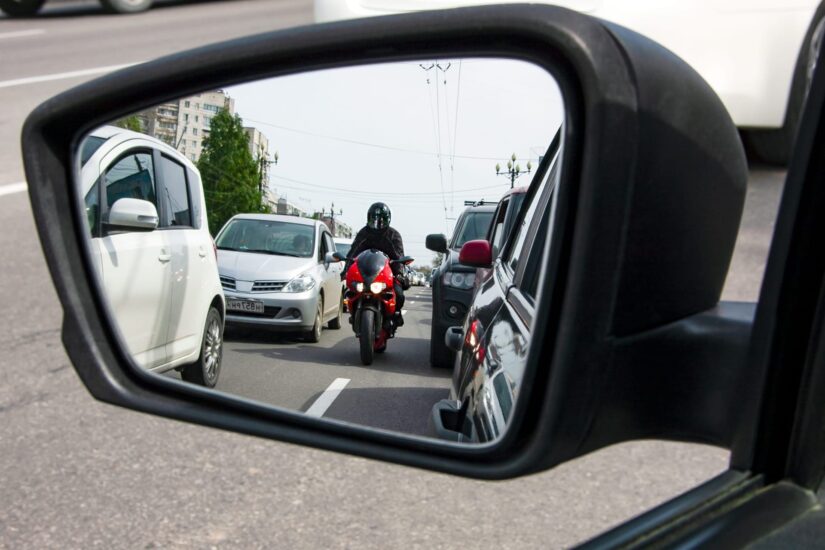Motorbike in car mirror photo