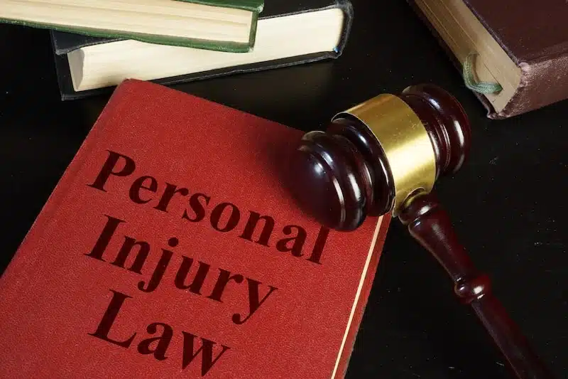 Red Personal Injury Law Book And A Judges Hammer