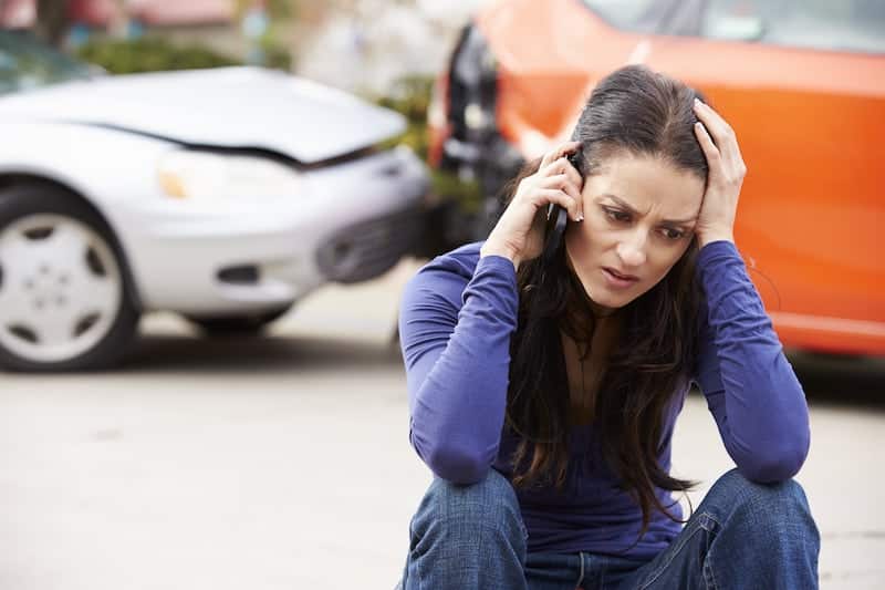 A Worried Woman Calling Someone After A Car Crash