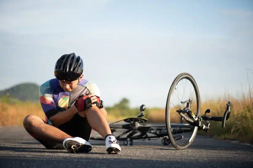 Cyclist Holding His Knee In An Accident