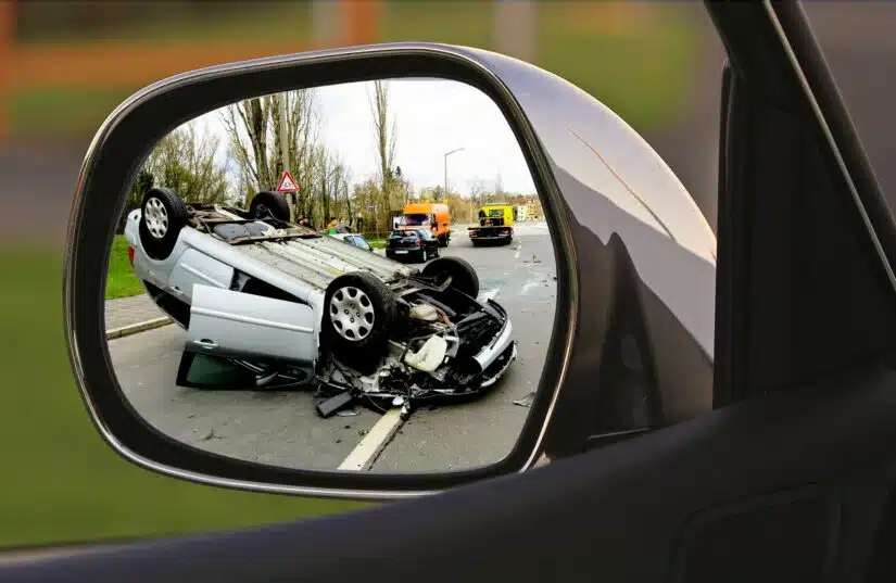 Vehicle Rollover Accident Seen Through A Side Mirror