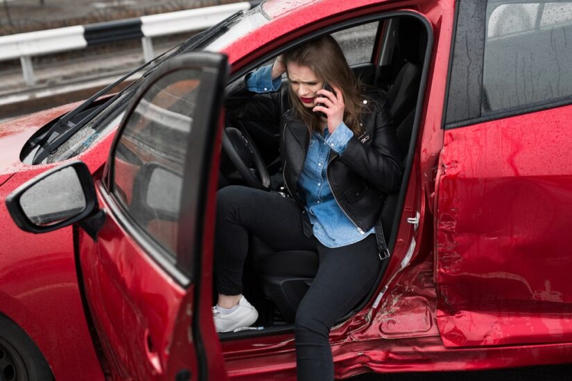 Upset Lady Sitting Inside Of A Damaged Vehicle Calling Someone On The Phone