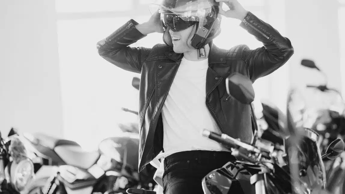 putting on a motorcycle helmet