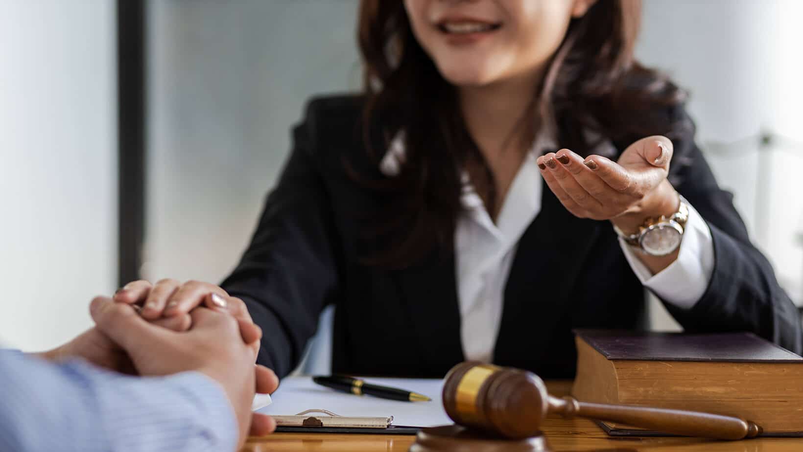 Businesswoman greets men with handshake