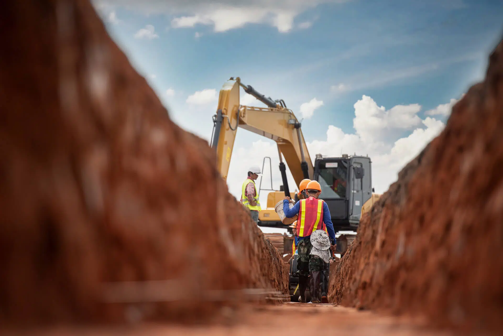Construction workers with excavator