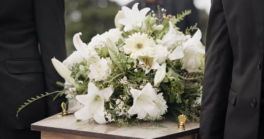 Bouquet atop a coffin, representing a wrongful death claim